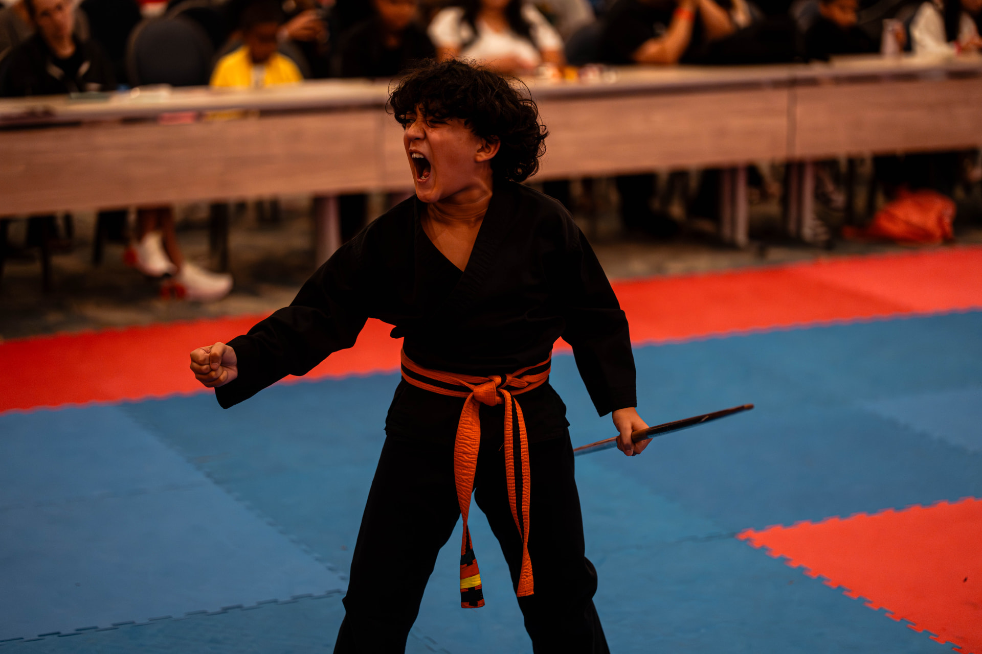 Weapons athlete mid-performance on the competition floor